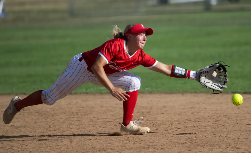 Fullerton shortstop Soleil Luna stretches but canât reach a grounder...