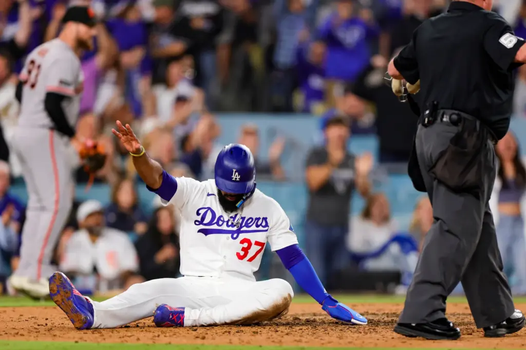 The Dodgers’ Teoscar Hernandez reacts after scoring on a pinch-hit...