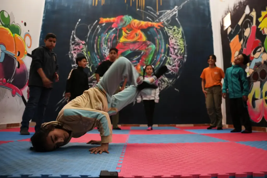 Palestinian children practice breakdancing