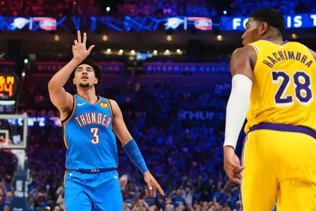 Oklahoma City Thunder guard Jared McCain, left, celebrates after making...