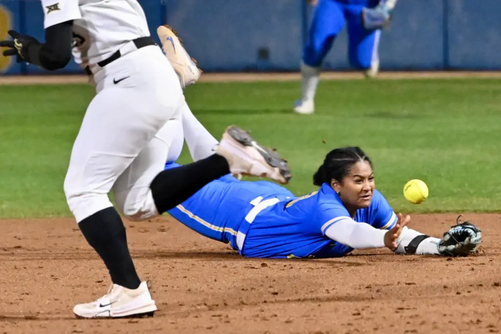Second baseman Kaniya Bragg #33 of the UCLA Bruins dives,...