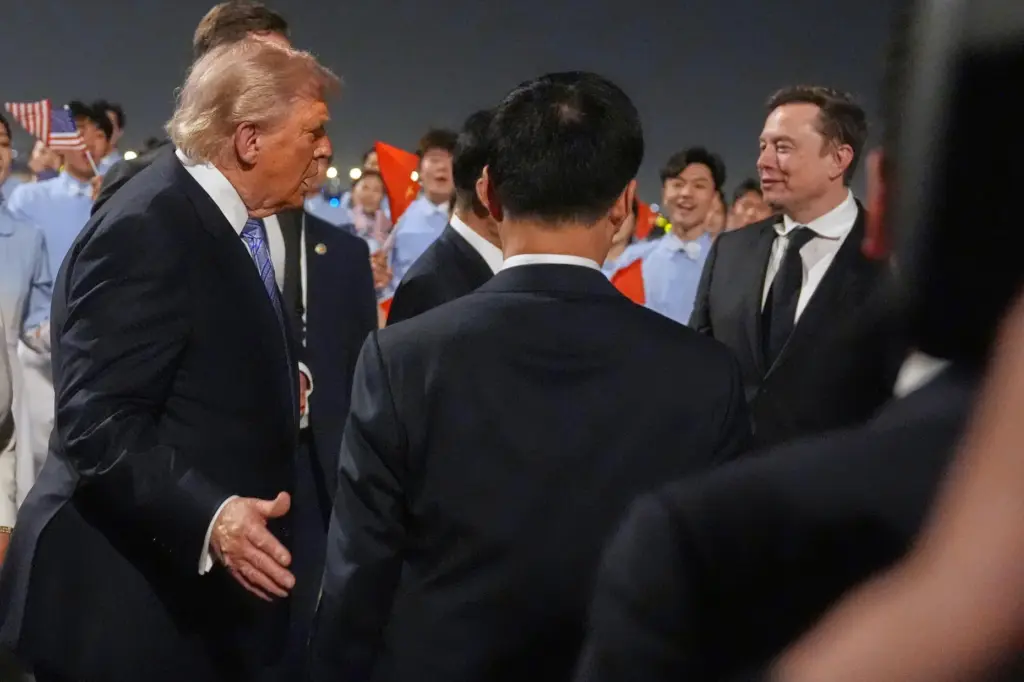 President Donald Trump talks with Elon Musk, right, during and...