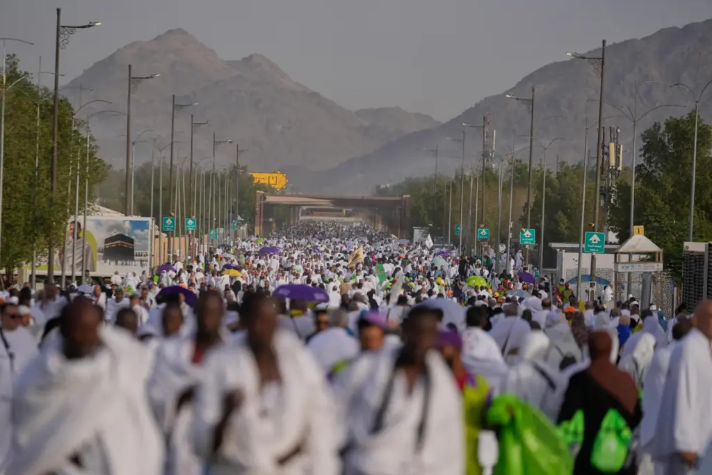 Muslim pilgrims walk towards the rocky hill known as the Mountain of Mercy
