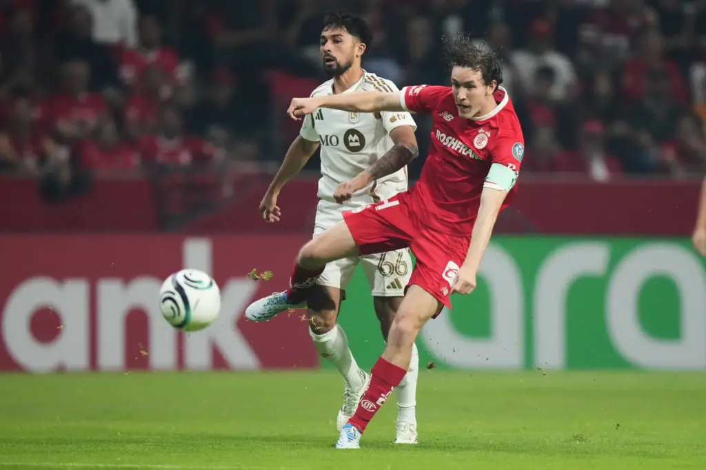 Toluca FC’s Marcel Ruiz, right, attempts a shot on goal...