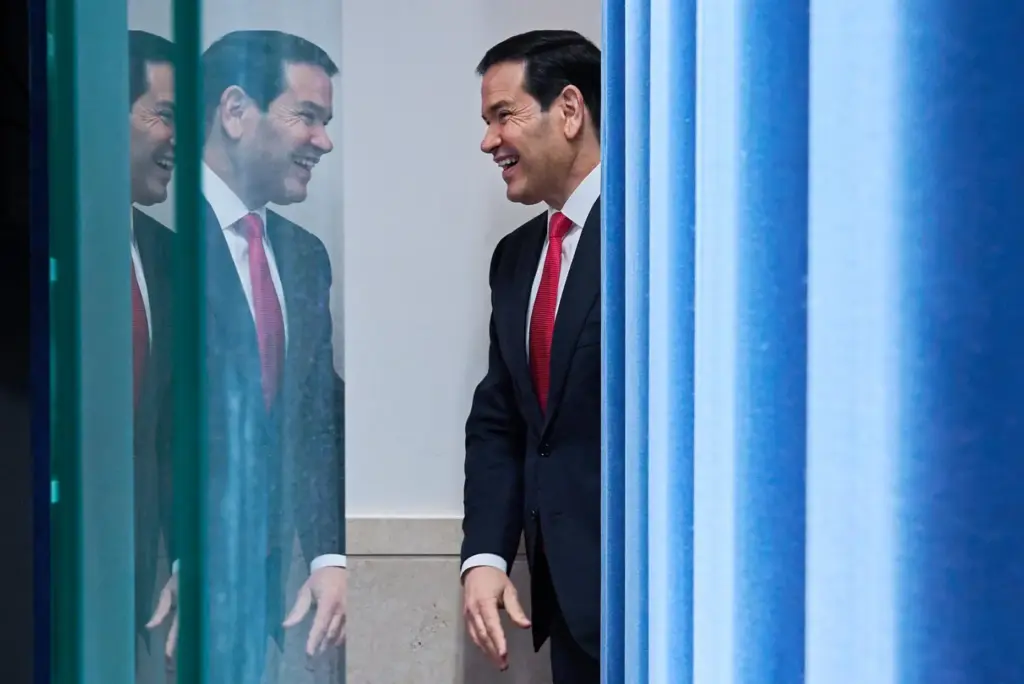 Secretary of State Marco Rubio smiles at reporters as he...