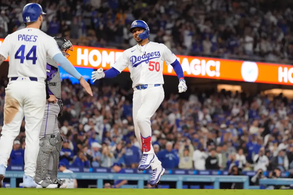 The Dodgers’ Mookie Betts, right, is congratulated by teammate Andy...