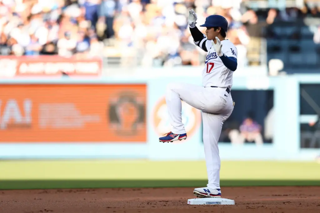 The Dodgers’ Shohei Ohtani gestures on second base after hitting...