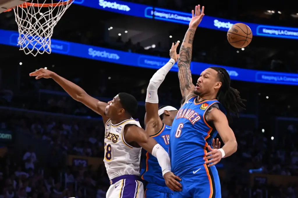 Lakers forward Rui Hachimura, left, is fouled by Oklahoma City...