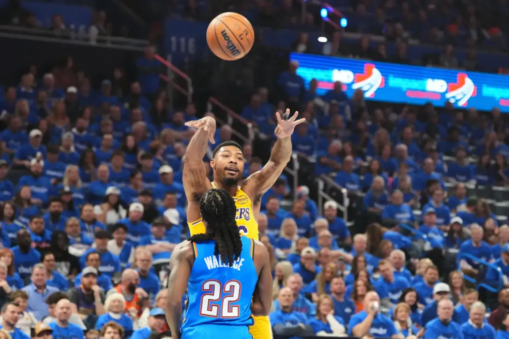Lakers guard Marcus Smart passes the ball over Oklahoma City...