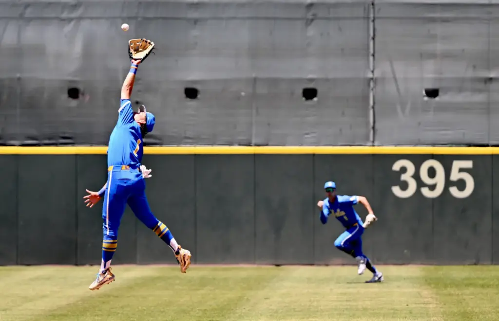 Shortstop Roch Cholowsky #1 of the UCLA Bruins leaps, but...