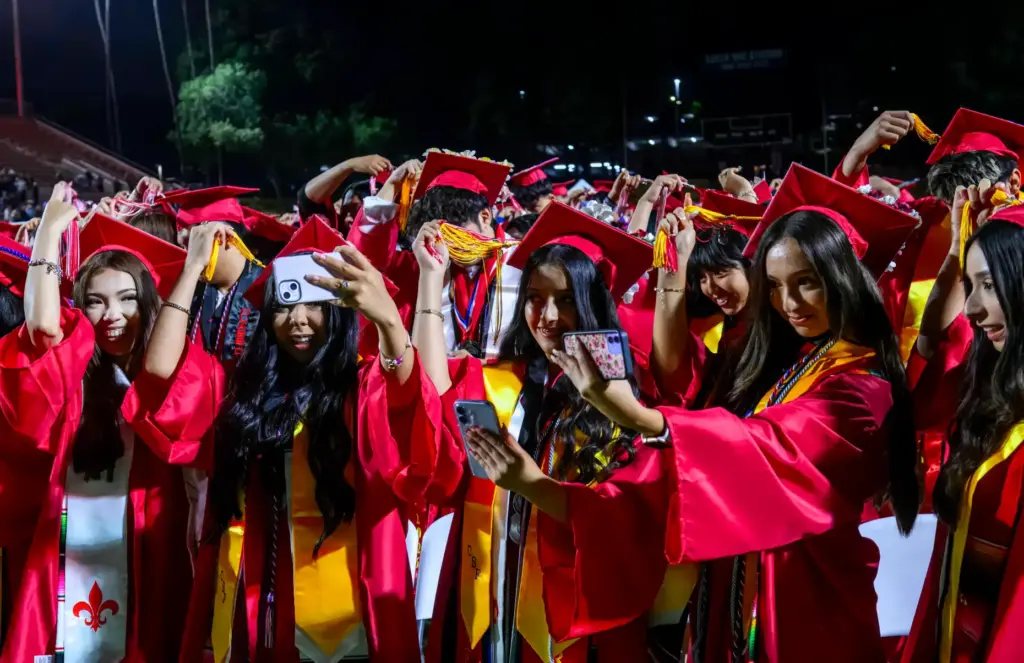 Santa Ana High School seniors move their tassels to the...