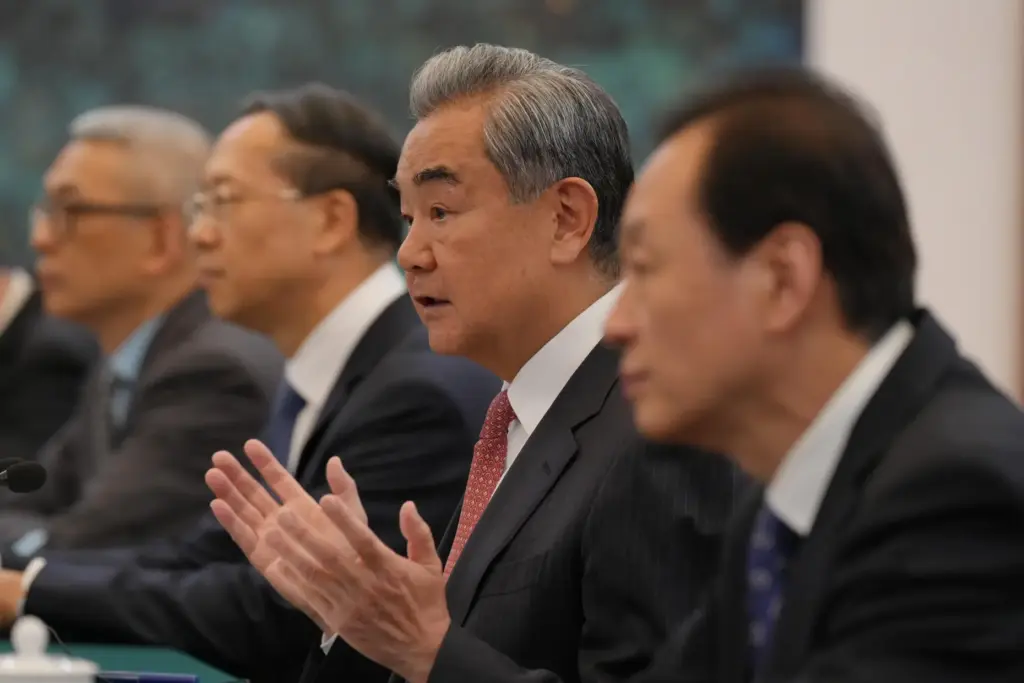 Chinese Foreign Minister Wang Yi speaks to U.S. Senator Steve Daines.