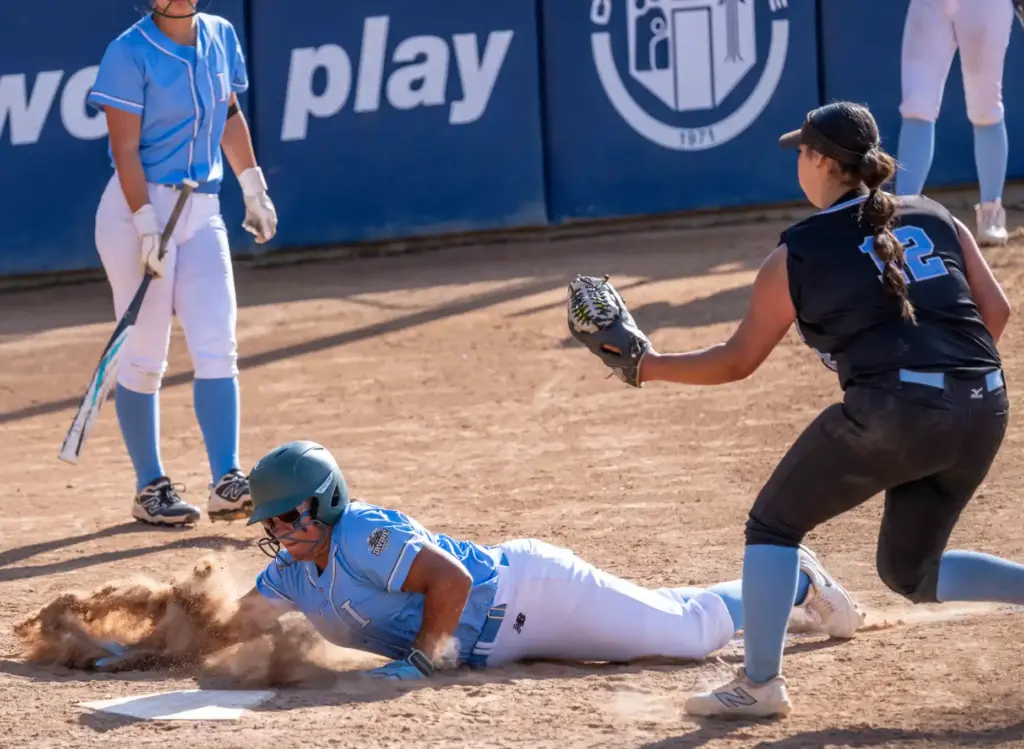 Irvineâs Andrea Torres slides into home plate to score, before...