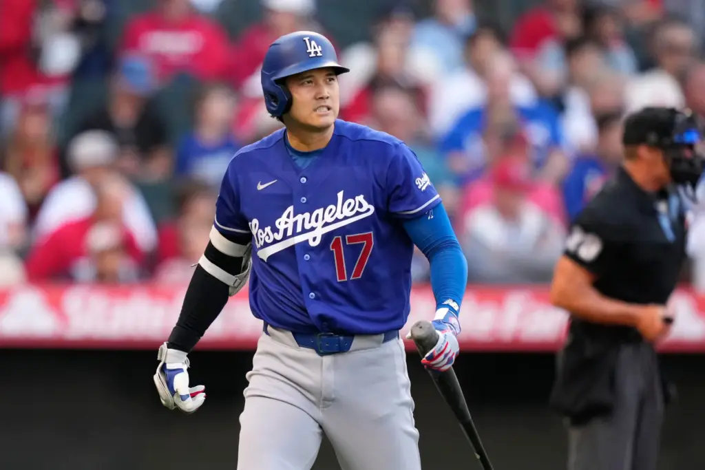 Dodgers star Shohei Ohtani walks back to the dugout after...