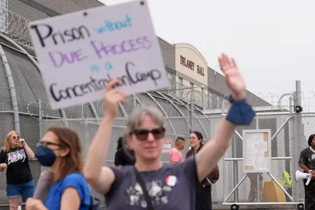 Demonstrators stand outside the Delaney Hall detention center during a...