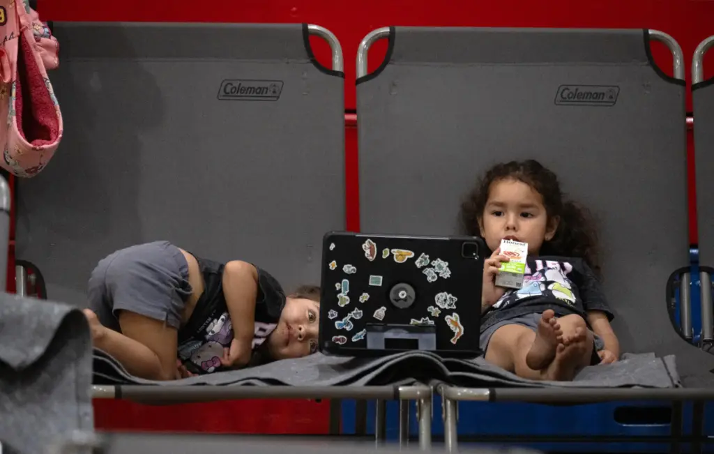 Oscar Maye keeps his daughters, Lucia, 2, left and Violetta,...