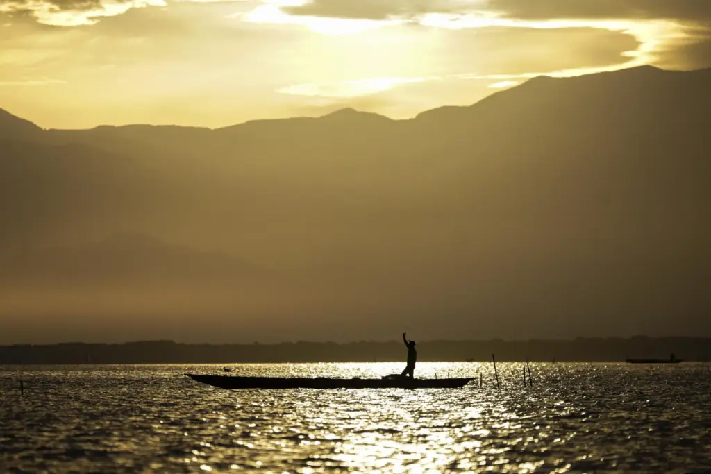 A fisherman throws his net to fish Thursday, April 30,...