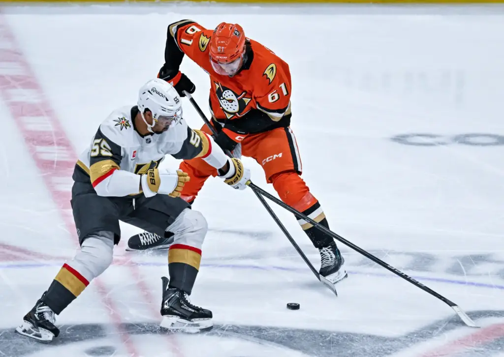The Golden Knightsâ Keegan Kolesar (55), left, and the Ducksâ...