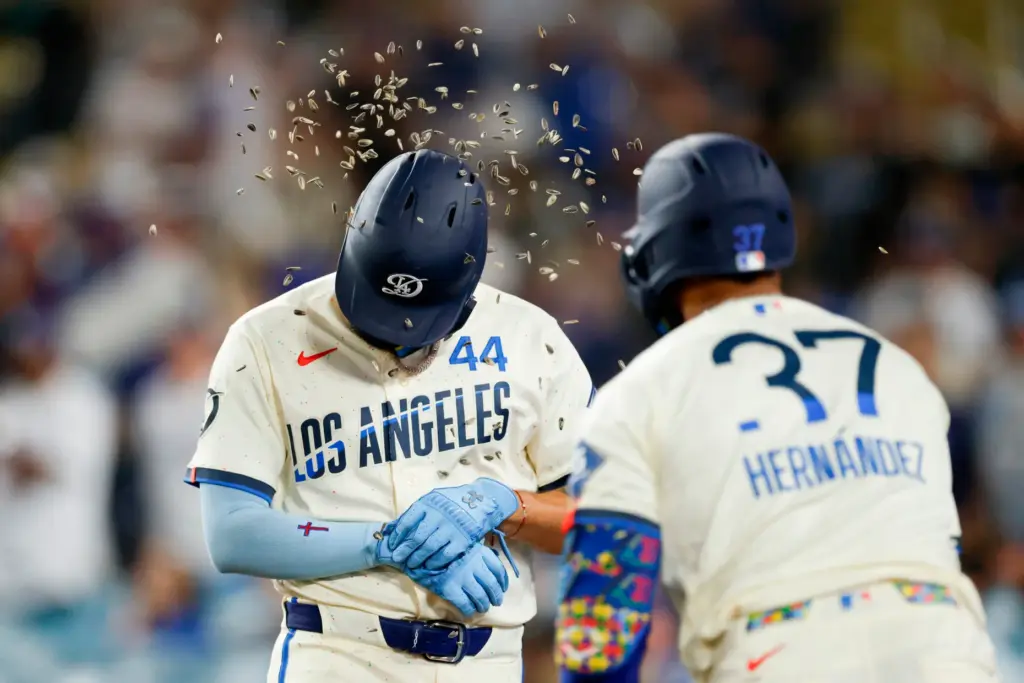 Dodgers’ Andy Pages (44) has sunflower seeds thrown on him...