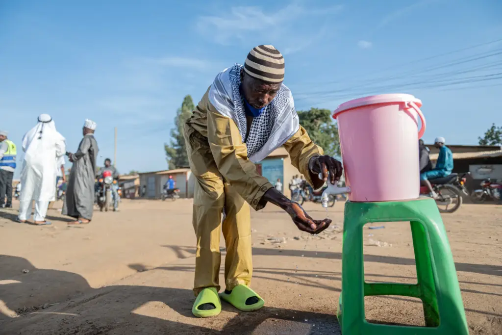 A Muslim man washes his hands as a precaution against Ebola.