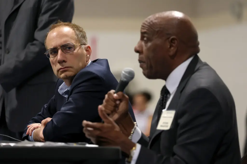 California Insurance Commissioner candidate Patrick Wolff looks on as fellow...
