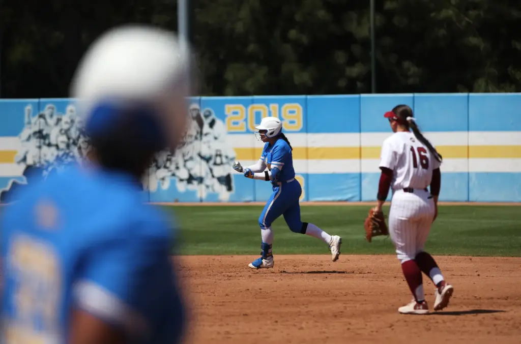 UCLAâs Bri Alejandre, center, celebrates after hitting a two-run homer...