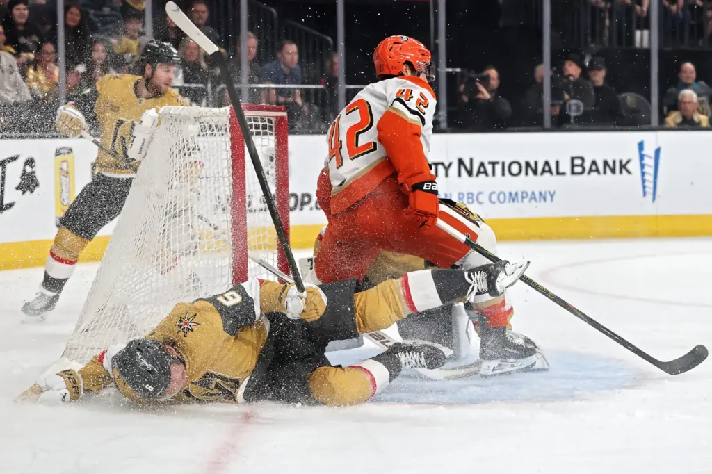 The Vegas Golden Knights’ Kaedan Korczak falls to the ice...