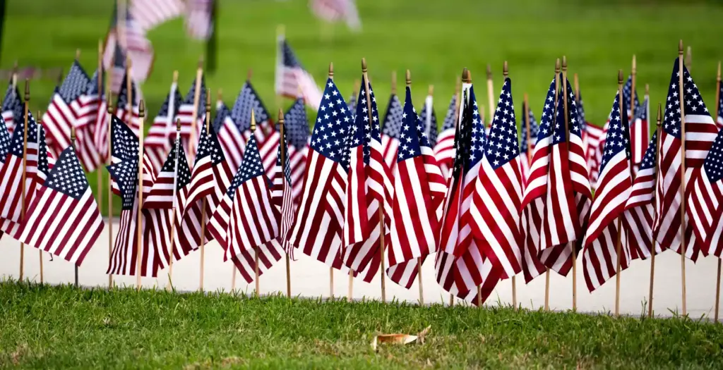 Flags line the walkway to the Memorial Day ceremony at...