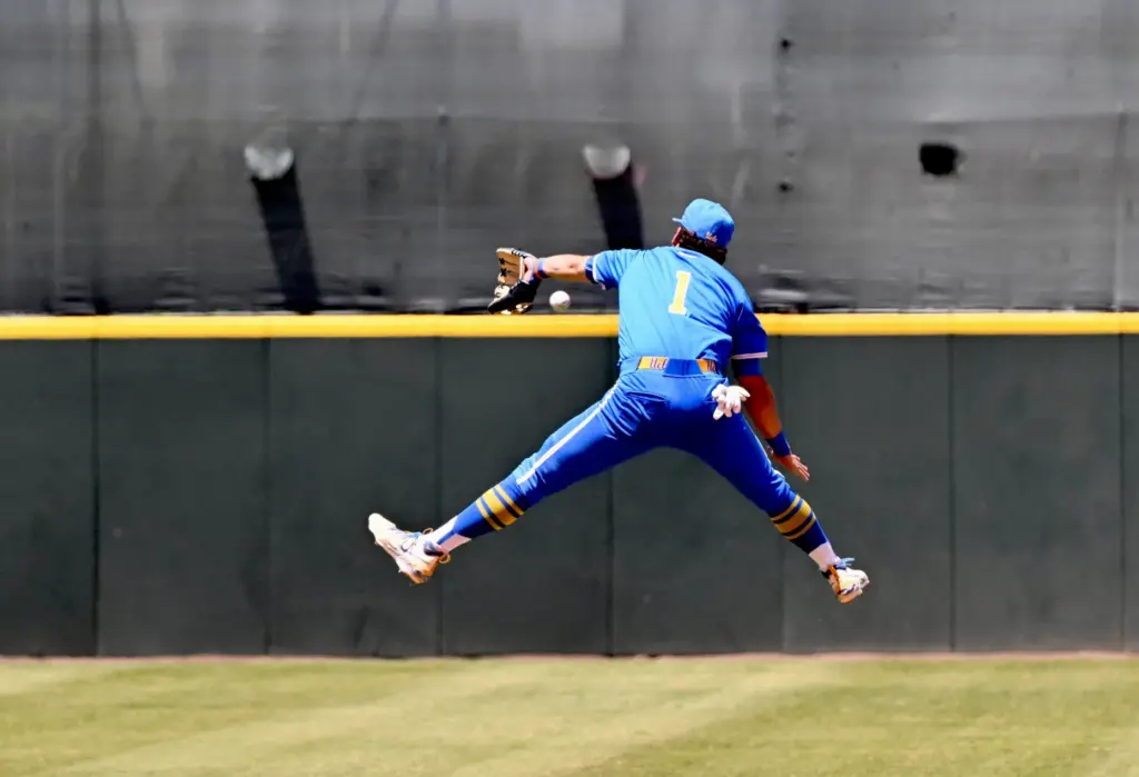 Shortstop Roch Cholowsky #1 of the UCLA Bruins leaps, but...