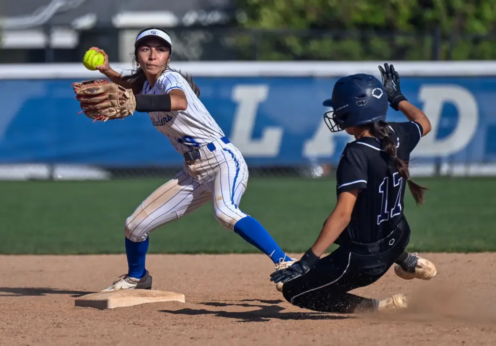 La Habra second baseman Milee Valencia, left, looks to complete...