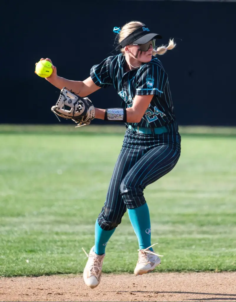 Aliso Niguel’s Sloan Lorenzo makes a complete turn after fielding...