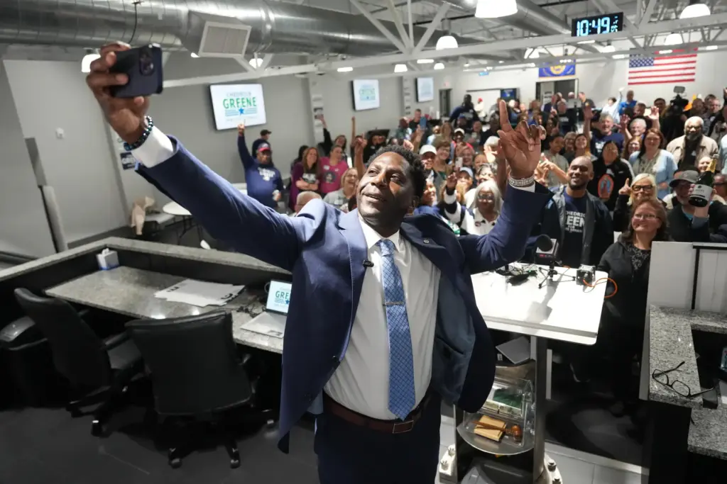 Chedrick Greene, Democratic candidate for 35th Senate District, takes a selfie with supporters.