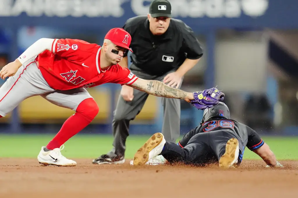 The Toronto Blue Jays’ Davis Schneider, right, steals second base...
