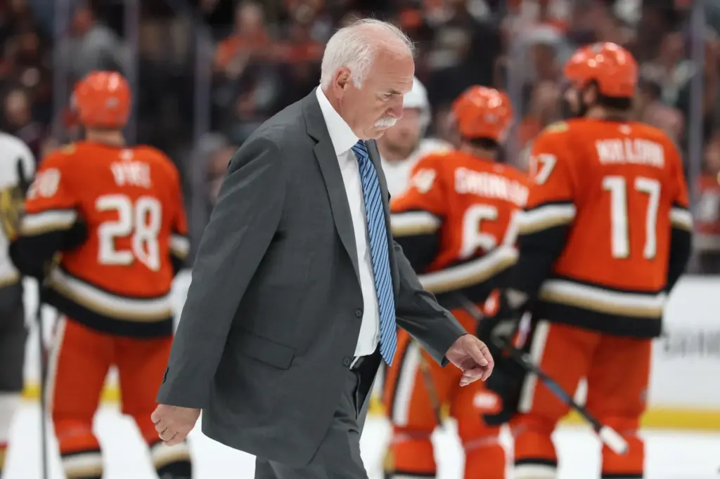 Ducks head coach Joel Quenneville walks across the ice after...