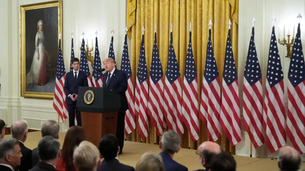 President Donald Trump speaks in front of American flags