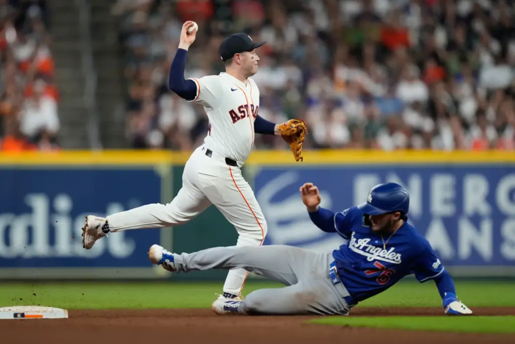 Houston Astros shortstop Nick Allen throws to first base after...