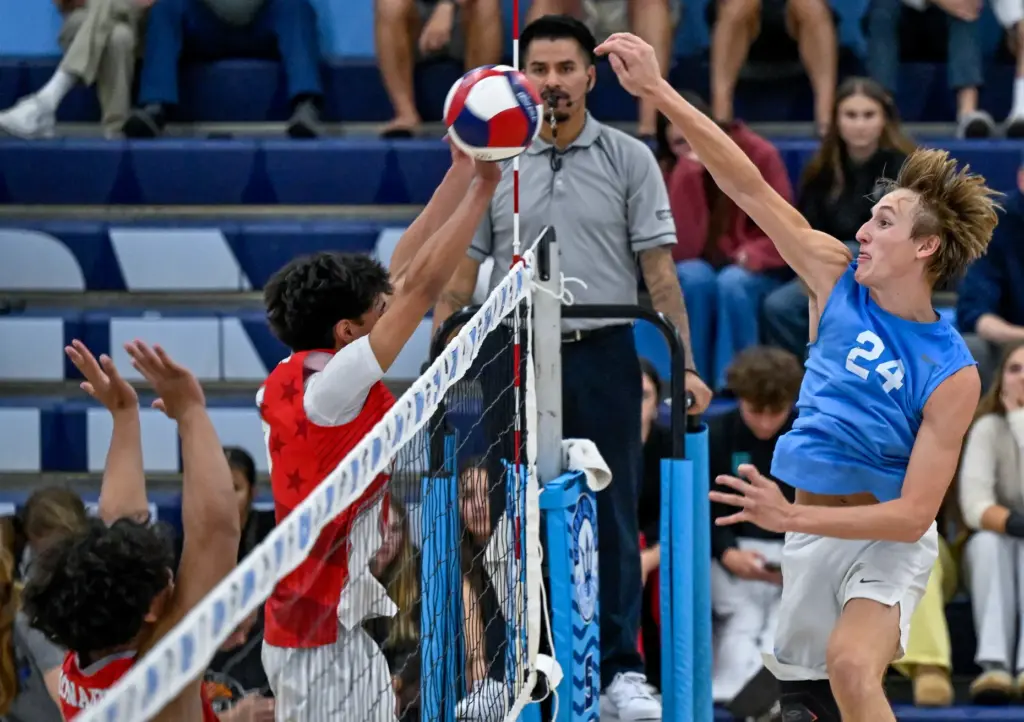 Corona del Mar outside hitter Ben Brown hits the ball...