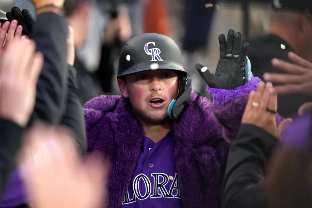 The Colorado Rockies’ Hunter Goodman is congratulated by teammates in...