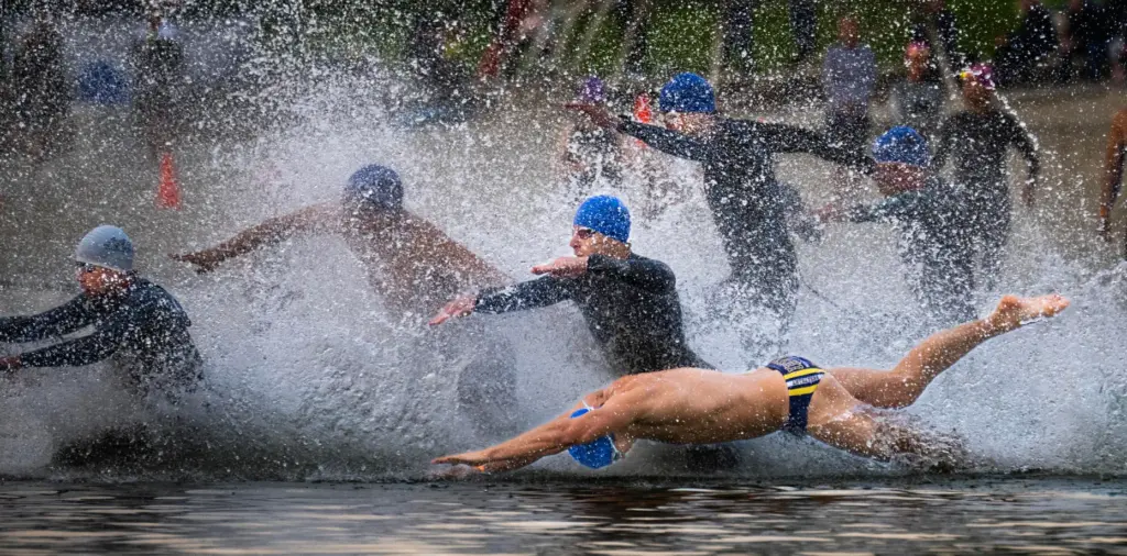 Male athletes hit the water during the OC Tri Series...
