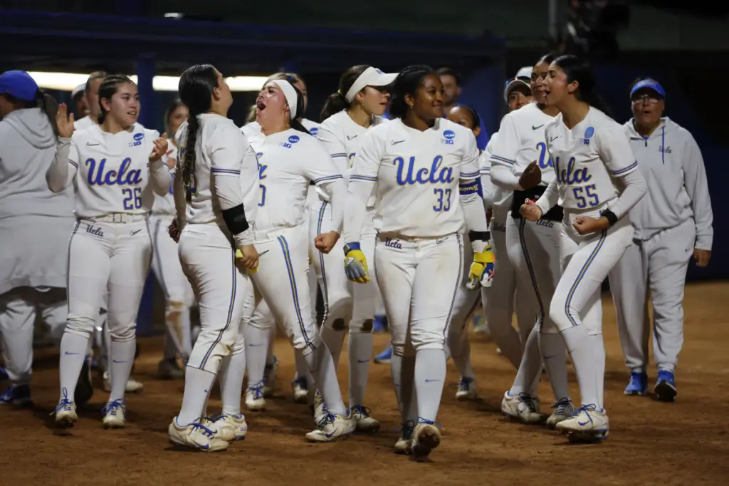 UCLA softball players celebrate after rallying to defeat California Baptist,...