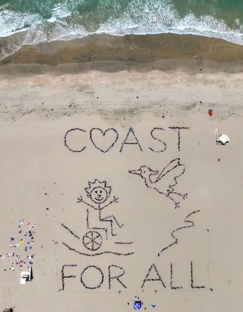 Over 1,000 kids form a giant artwork in the sand...