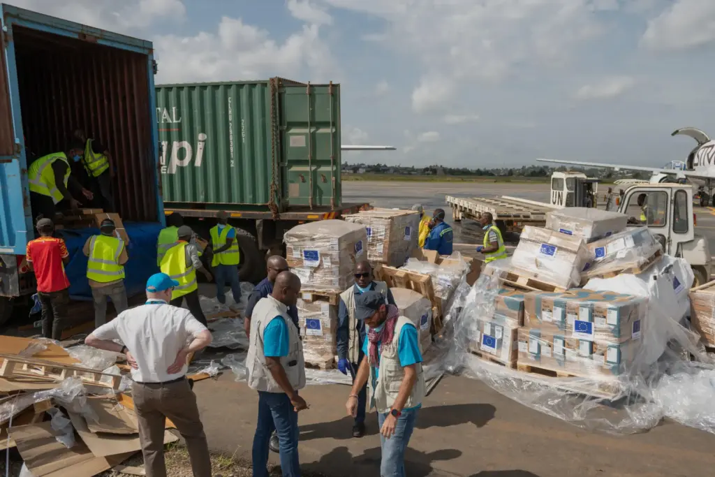 Workers offload medical and emergency supplies donated by the European Union.
