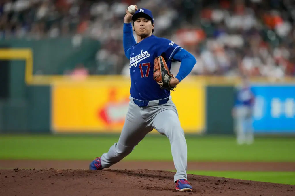 Dodgers starting pitcher Shohei Ohtani throws to the plate during...