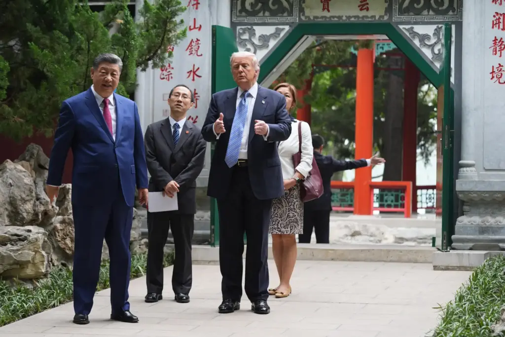 President Donald Trump walks with China's President Xi Jinping.
