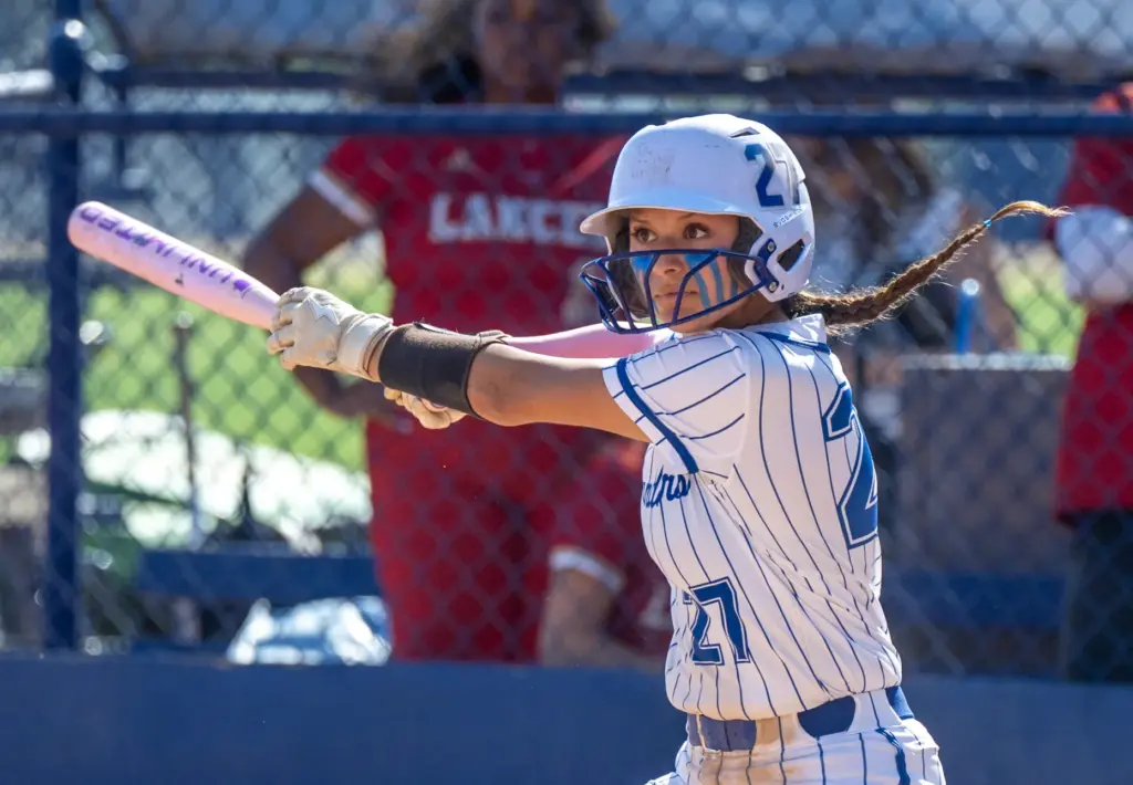 La Habra infielder Andrea Langenberg watches her hit before running...