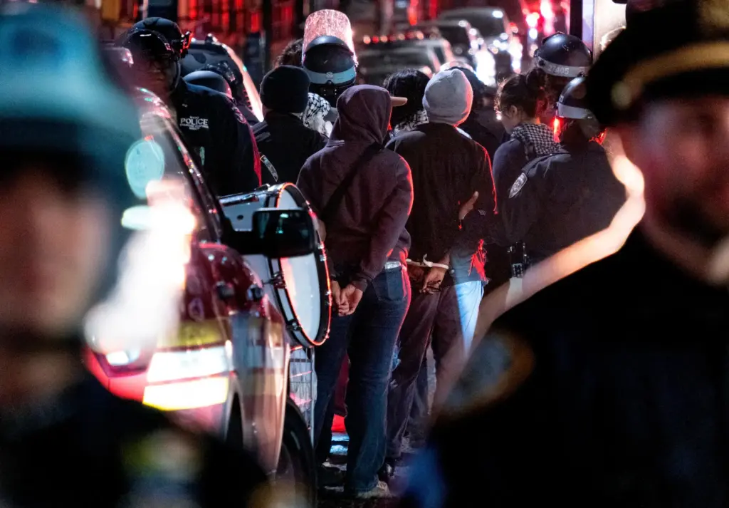 FILE – New York City police officers take people into...
