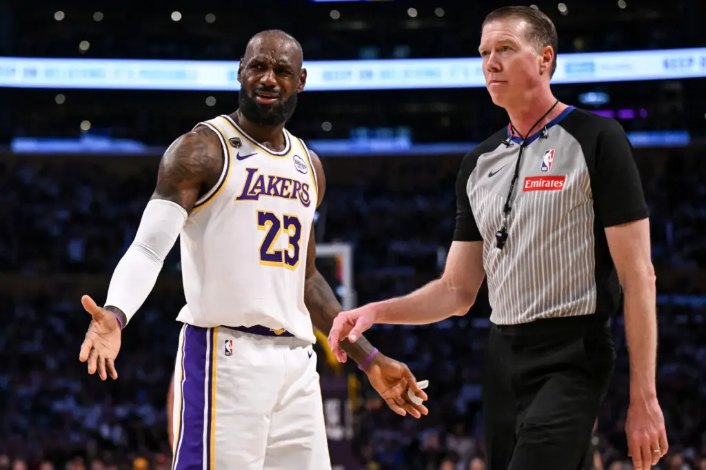 Lakers star LeBron James disputes a foul call with an...