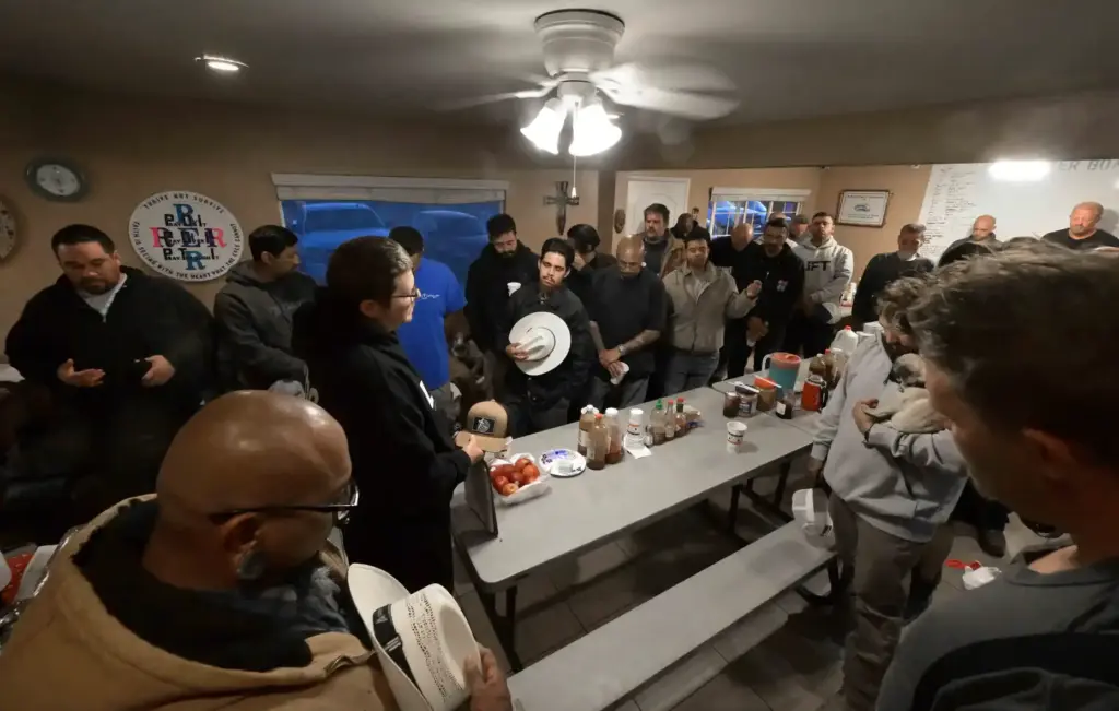 River’s Edge Ranch âranchersâ pray before breakfast on Friday, May...