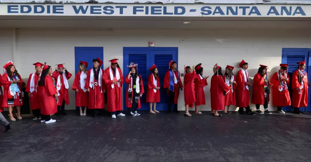 Santa Ana High School graduates line up before the start...