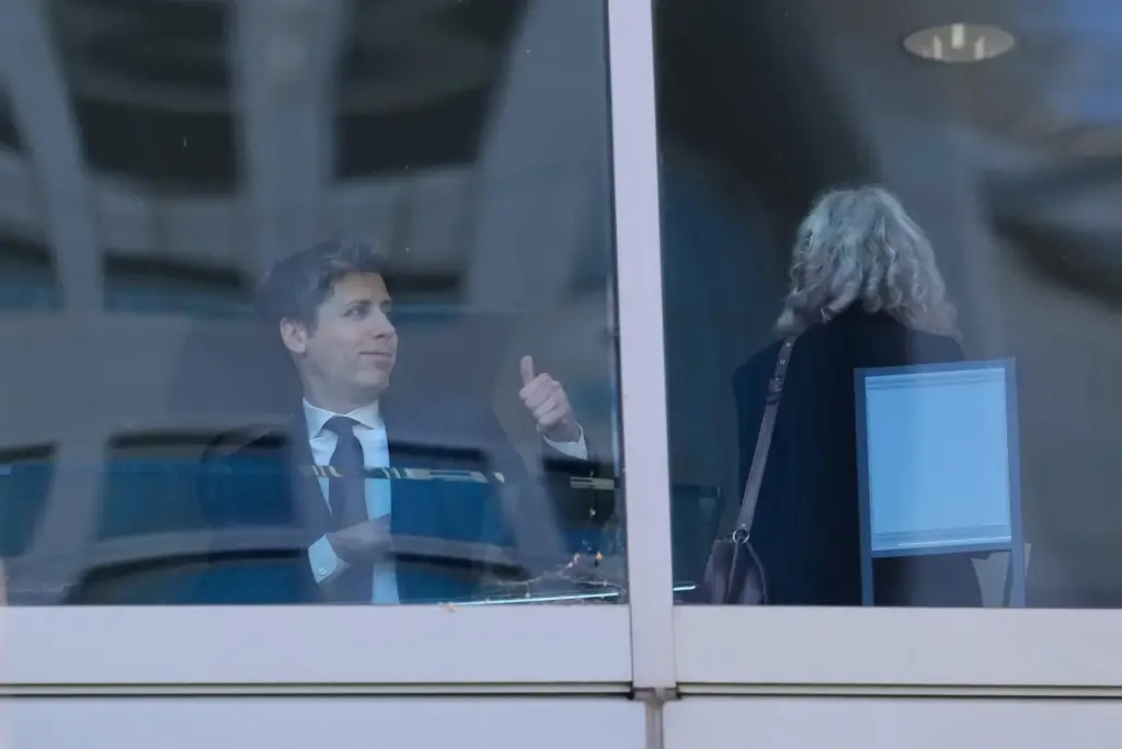 Sam Altman gestures as he walks through a hallway inside the U.S. District Court in Oakland.